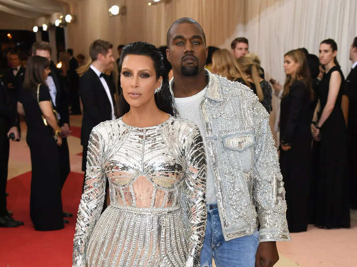 Kim Kardashian and Kanye West wore matching metallic silver Balmain ensembles in May 2016.