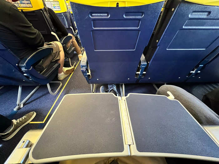 In the exit row, it took me a few minutes of fidgeting to find my tray table, which folded out of the armrest. It can also be folded in half, where there