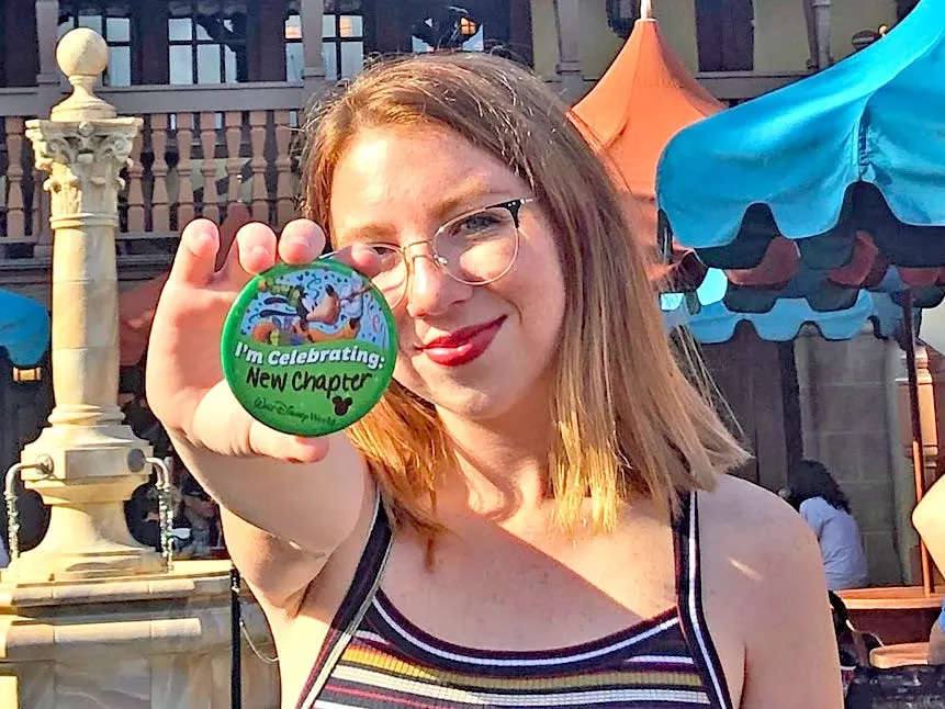 jordyn holing up a disney button with "I