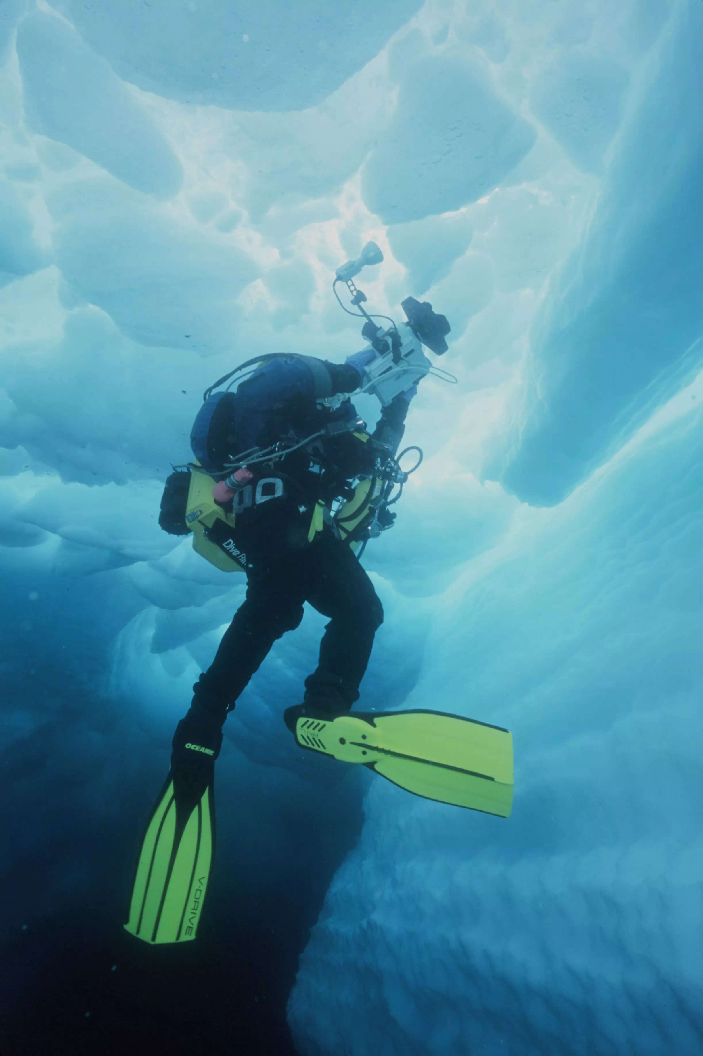 A diver floats inside iceberg B15