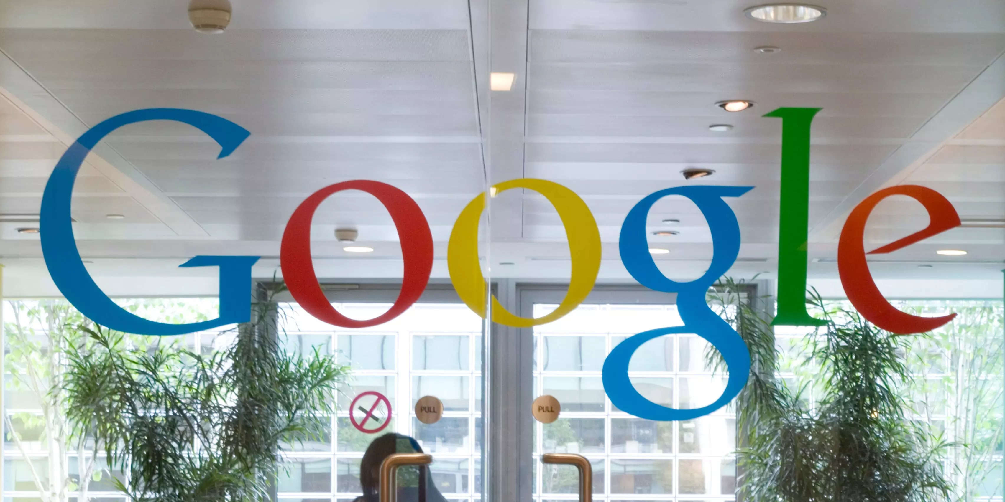 A Google logo on a pair of glass doors.