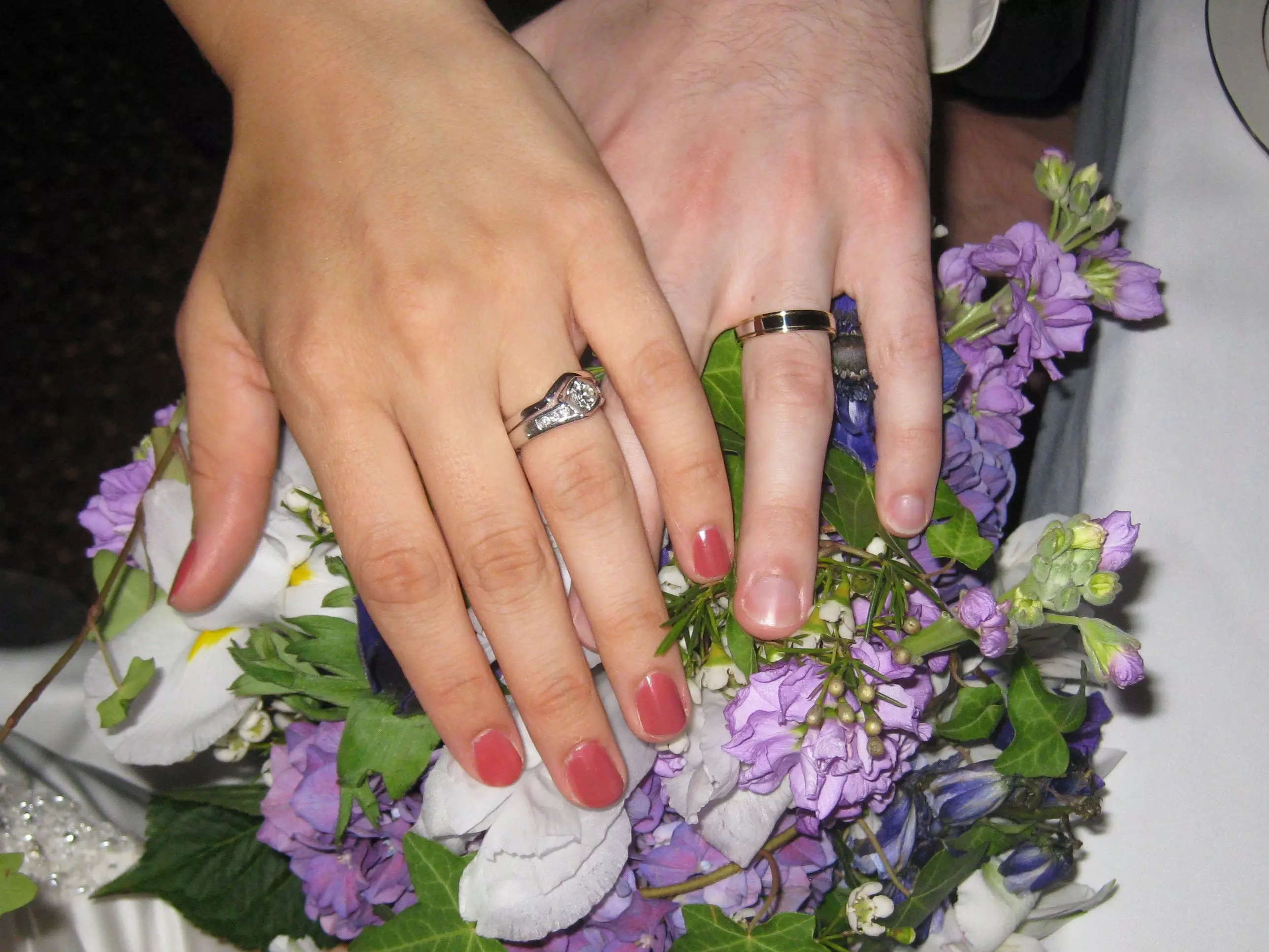 Stacy Brooks hand over a bouquet of flowers with her wedding ring, and her husband