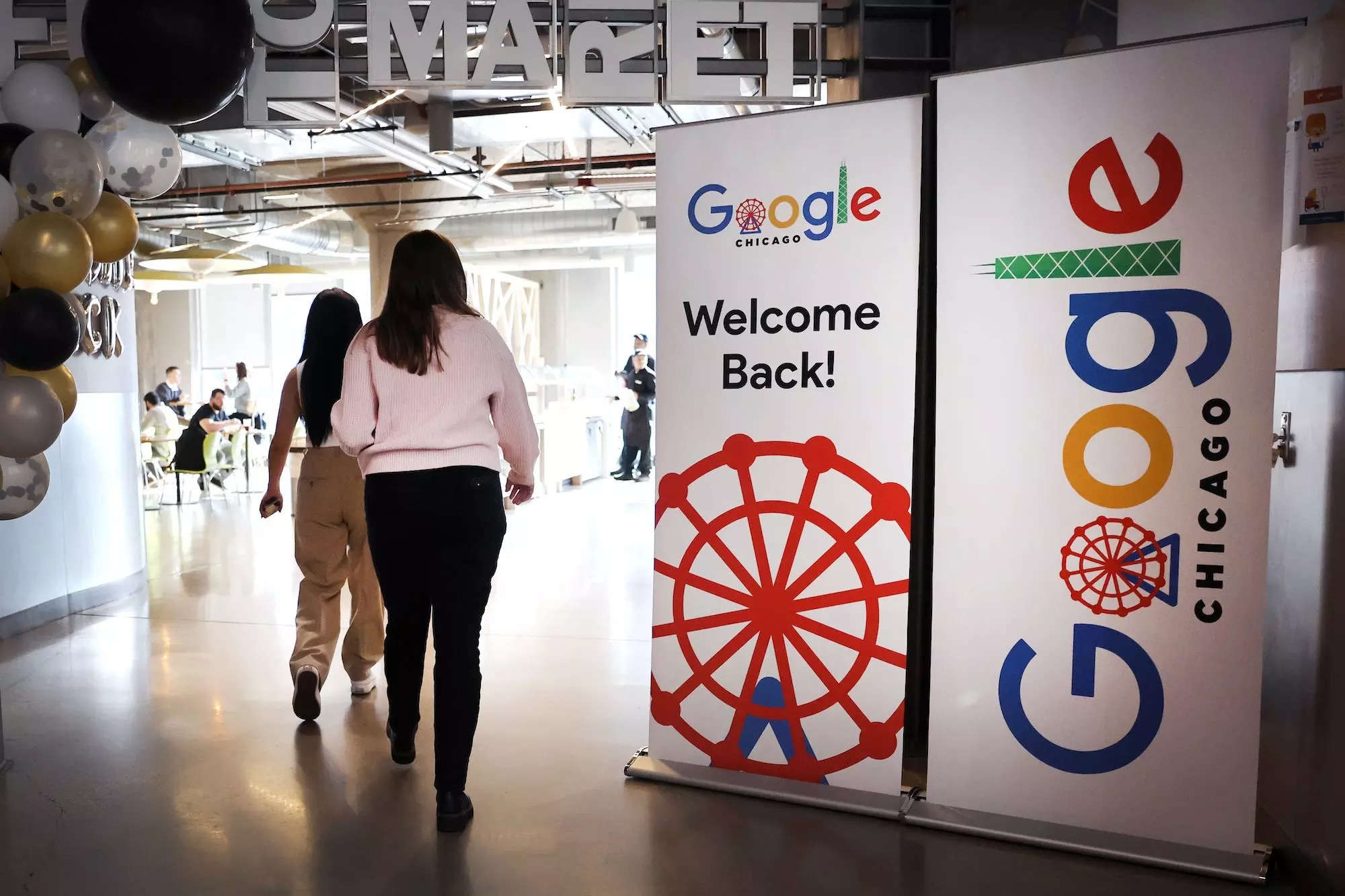 Google employees walk into a cafeteria at Google