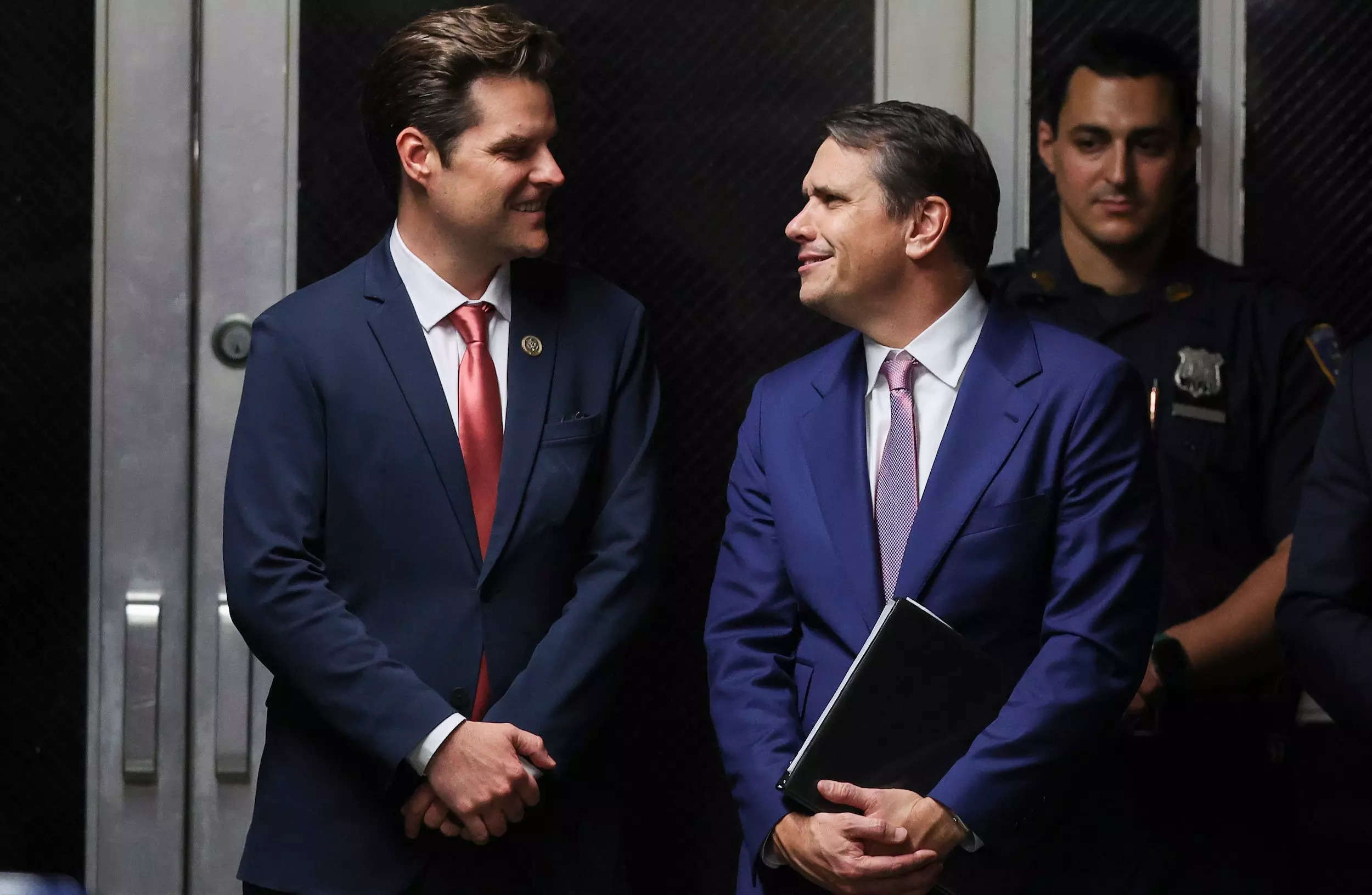 Rep. Matt Gaetz, left, R-Florida, chats with Donald Trump attorney Todd Blanche in the hall outside the hush-money trial.