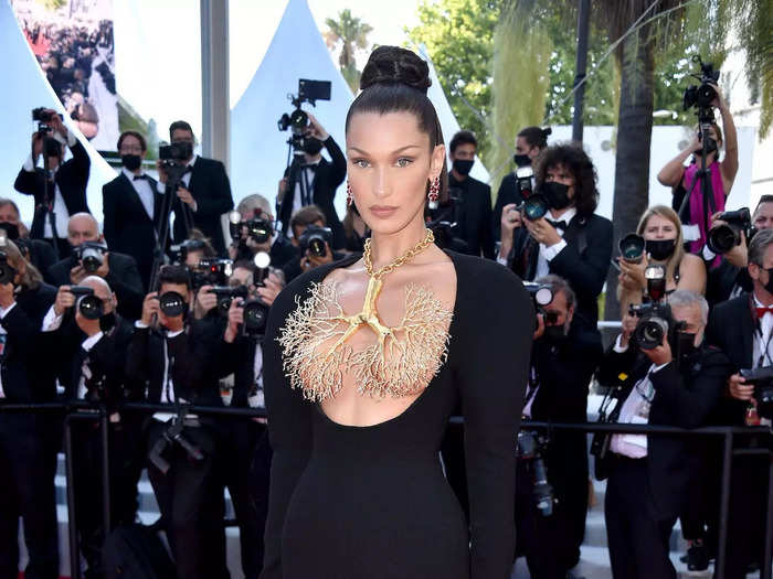 Hadid wore what was arguably her boldest Cannes look in 2021. She walked the red carpet in a black dress with a scoop neckline that extended below her chest.