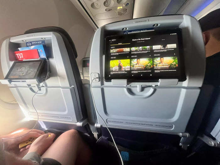 I prefer the tablet holder because it creates a better viewing angle for people, like myself, who bring our own inflight intertainment.