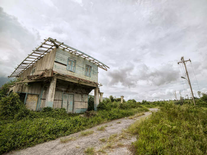 Boarded-up homes near the mountain have an eerie appearance.