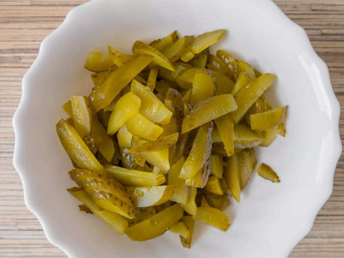 While relish is a common addition to hot dogs, you can also chop up your own pickles.