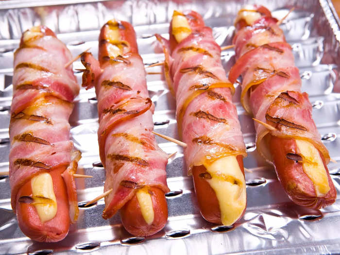 Stuff your hot dogs with cheese and wrap them in bacon for a decadent twist on this cookout favorite.