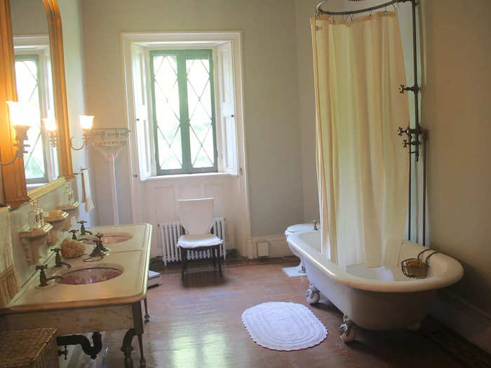 A bathroom in the hallway was furnished with pink double sinks sourced from Trenton, New Jersey.