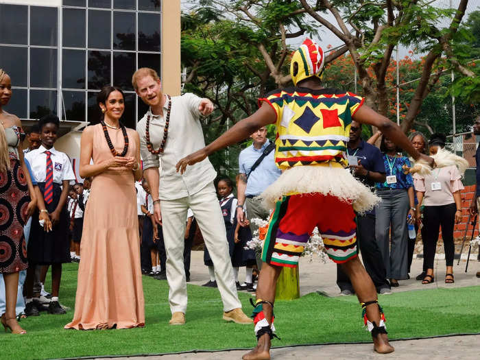 The peach dress Meghan wore to visit Lightway Academy stood out with architectural detailing.