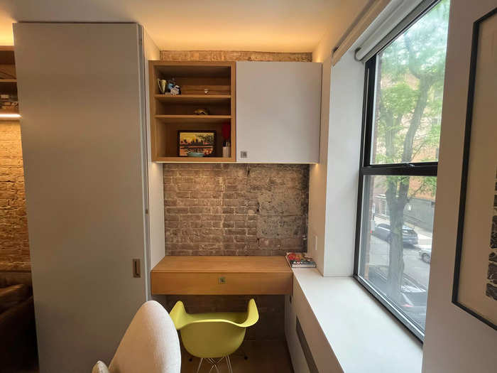 Leaving patches of exposed brick — rather than putting built-in cabinets everywhere — also helps the space breathe. 