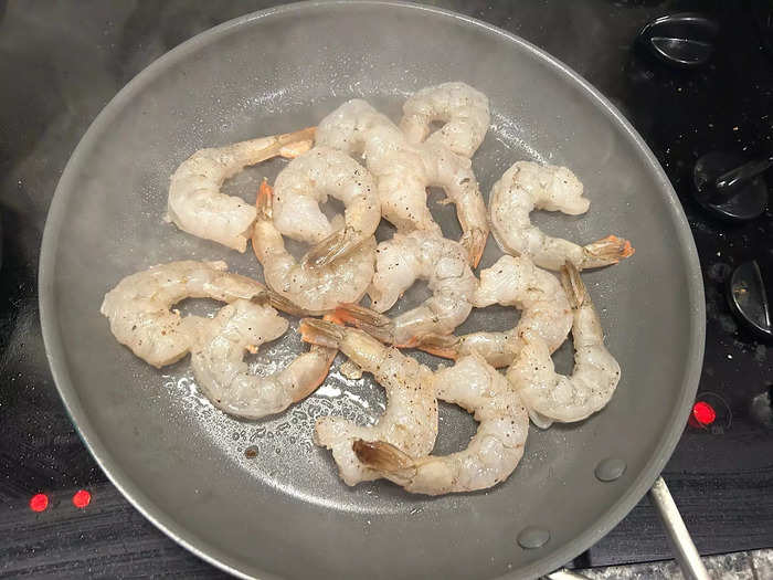 To cook the shrimp, I placed a second nonstick frying pan over high heat and added a drizzle of olive oil.