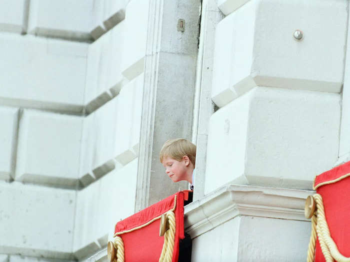 Harry was photographed sweetly looking down at the crowds in front of Buckingham Palace at the same celebration.