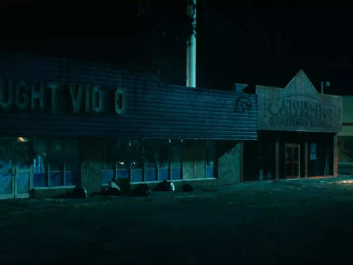 Butcher secretly meets Victoria at an abandoned Vought Video store next door to a Church of the Collective building.