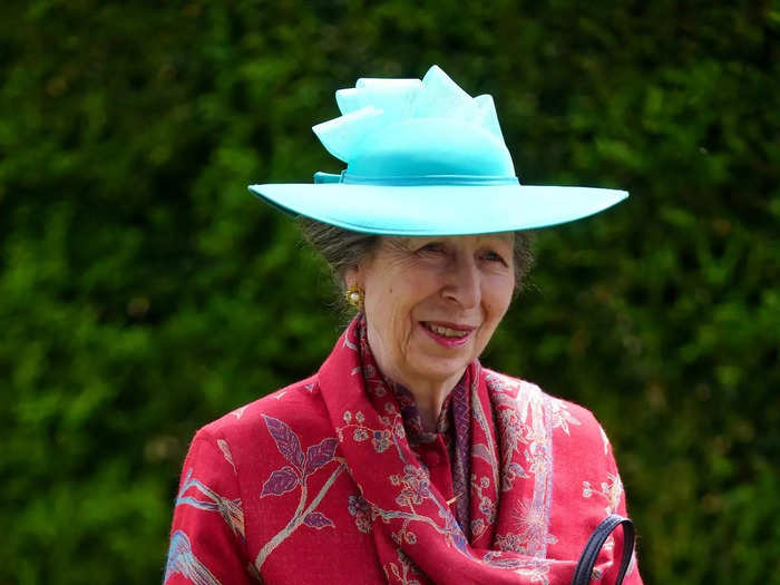 Princess Anne paired a turquoise hat with one of her favorite silk red coats on day one of Royal Ascot. 