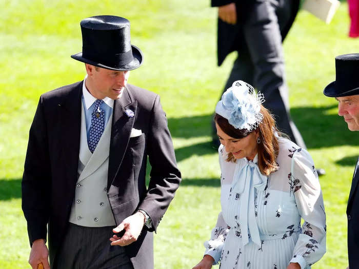 Wearing a traditional suit and top hat, Prince William was spotted catching up with his mother-in-law, Carole Middleton, on day two of Royal Ascot.