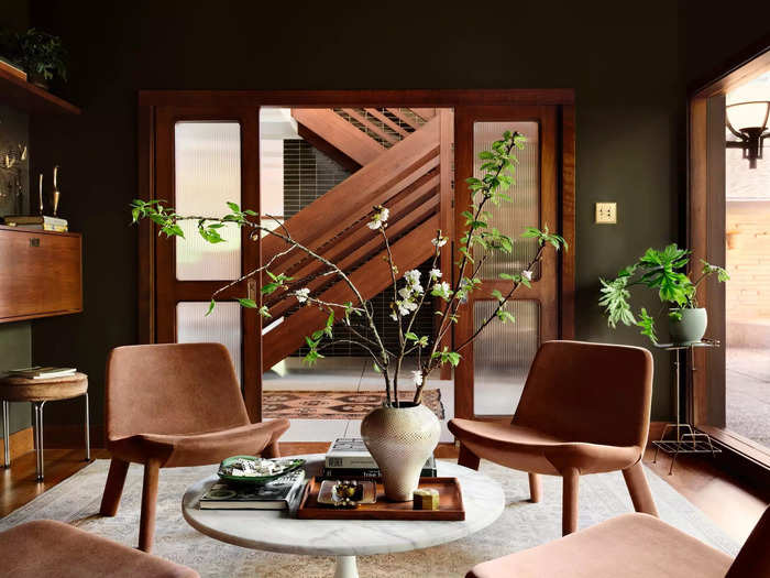 The library sits opposite the staircase, as seen through its sliding glass doors.