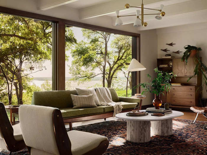 Windows covered the entirety of one wall in the living room, providing a view of the nearby lake.