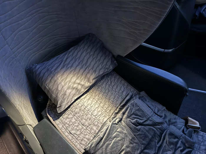 Before the lights turned down in the cabin, a flight attendant came to make my bed.
