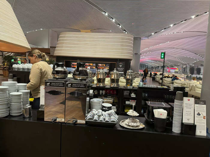 A coffee station had a barista making drinks to order.