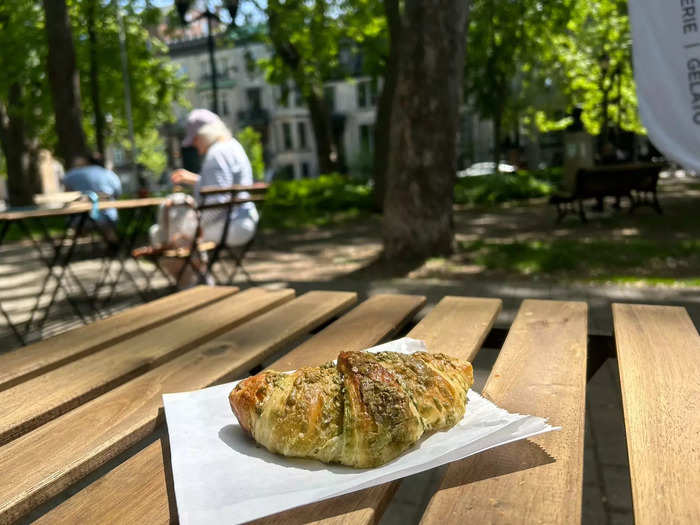 My friend and I grab fresh pistachio croissants that are still warm. 