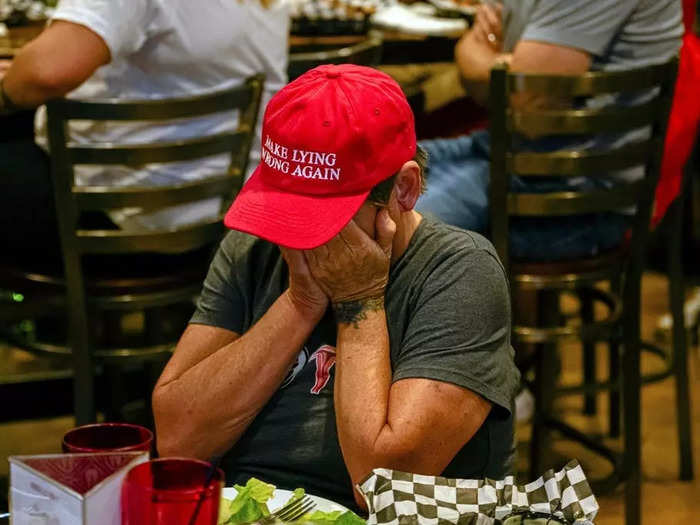 Another viewer at the Old Louisville Tavern, Amy McKinley, took a similar position while wearing a red "Make lying wrong again" baseball cap.