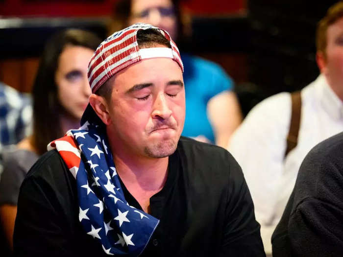 A patron draped in an American flag at a pub in San Francisco seemingly struggled to keep his composure.