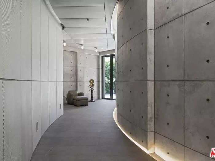 Curved walls lead to the guest bedroom and a separate guest apartment.