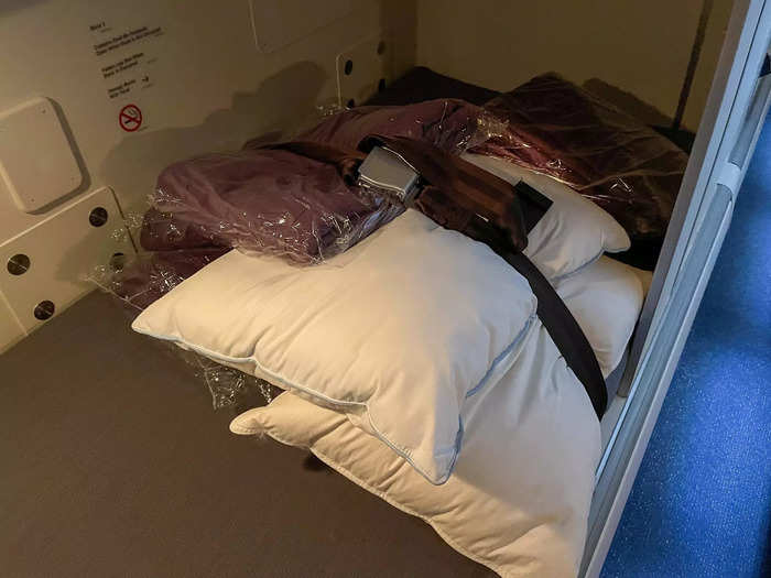 Each bed had a seat belt for potential turbulence, with blankets and pillows strapped underneath.