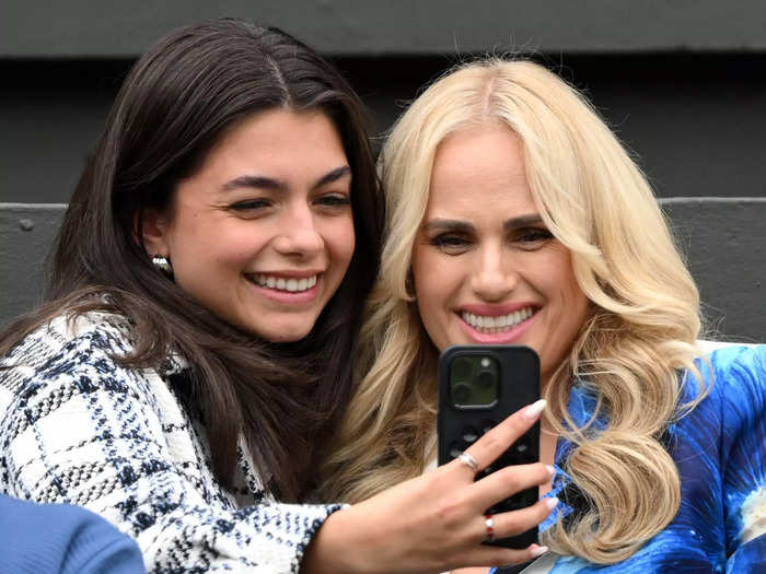 Actor and producer Rebel Wilson was seen taking selfies with a fellow spectator in a bright floral blazer by Alice and Olivia.