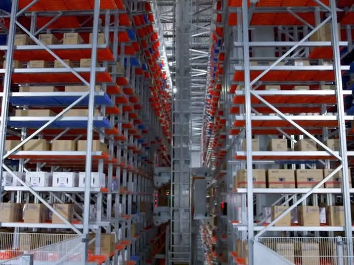 The shelves reach as high as 80 feet and are accessed entirely by robots