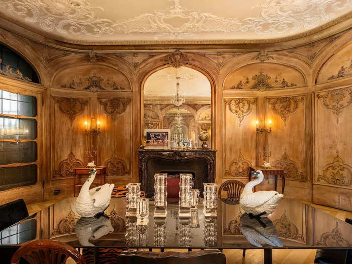 The dining room features ornate wood paneling and 12-foot ceilings.