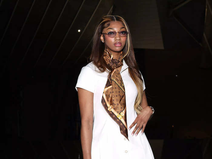 WNBA star Angel Reese looked ready to fly to the South of France in this white dress and brown Louis Vuitton scarf.