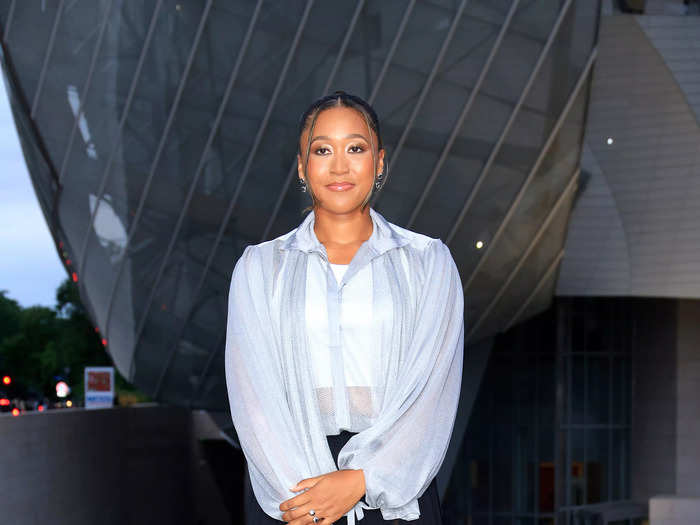 Tennis star Naomi Osaka chose a sheer baby-blue blouse and a high-low skirt. As an LV ambassador, her Louis Vuitton purse was front and center.