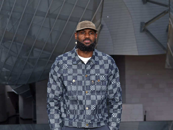 Two-time Olympic gold medalist LeBron James wore a blue patchwork jacket, blue pants, and crisp white sneakers.