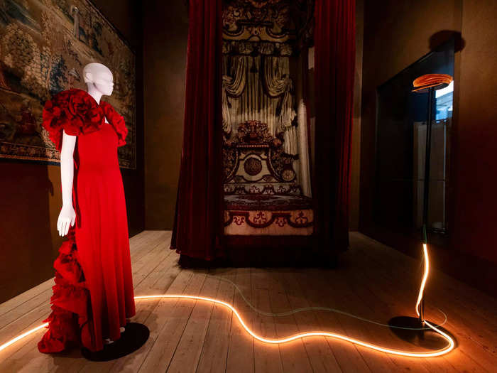 Items from "Red" can be found near a lavishly upholstered 18th-century four-poster bed and ornate tapestry.