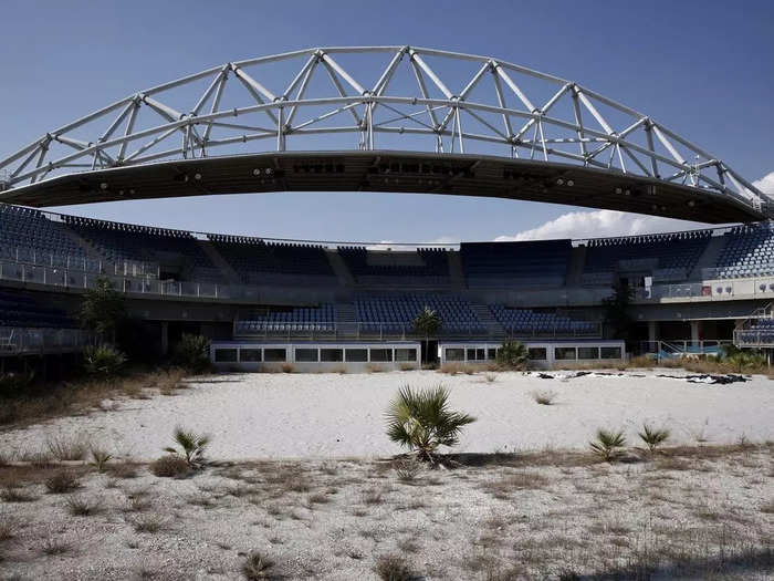 The beach volleyball court in Athens was consumed by weeds.