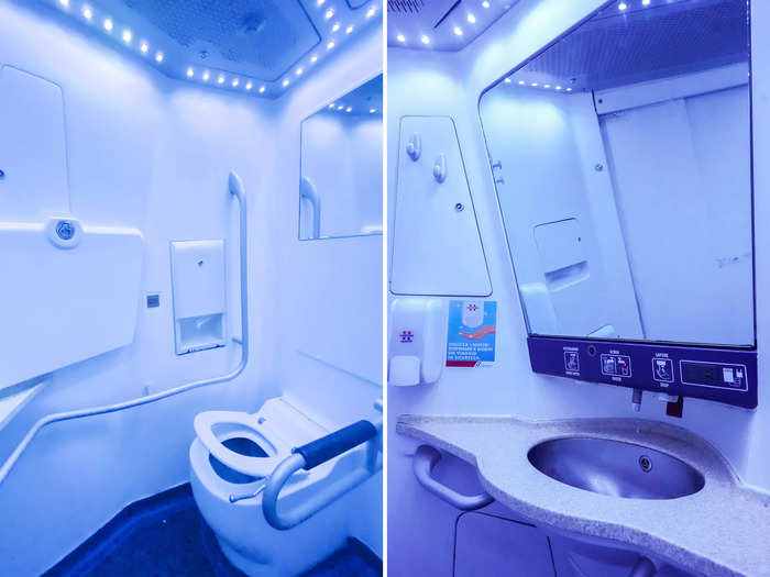 I thought the bathroom felt spacious and clean in business class, with blue lighting and a large mirror above the sink.