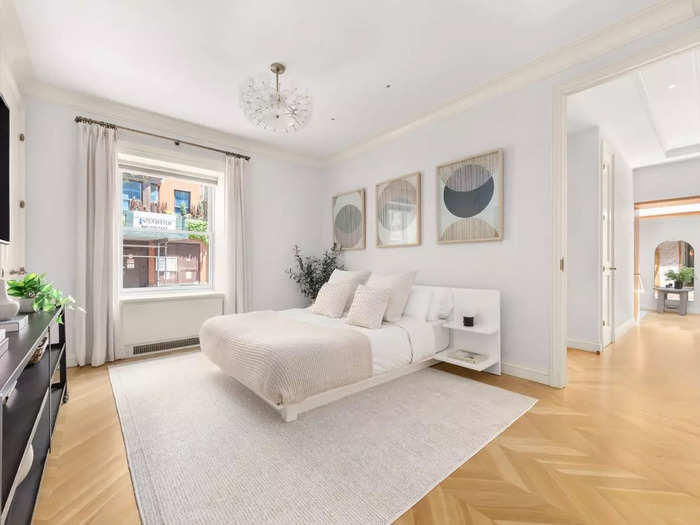 The primary bedroom is flush with natural light and includes a dramatic walk-in closet.  