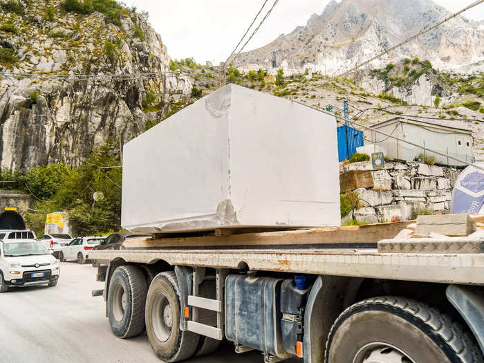 From there, machinery moves the slab onto the bed of a truck to be driven down the mountain and transported around the world.