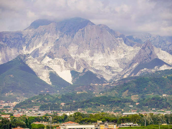 From far away, the Apuan Alps in Carrara, Italy, look snowcapped. But they