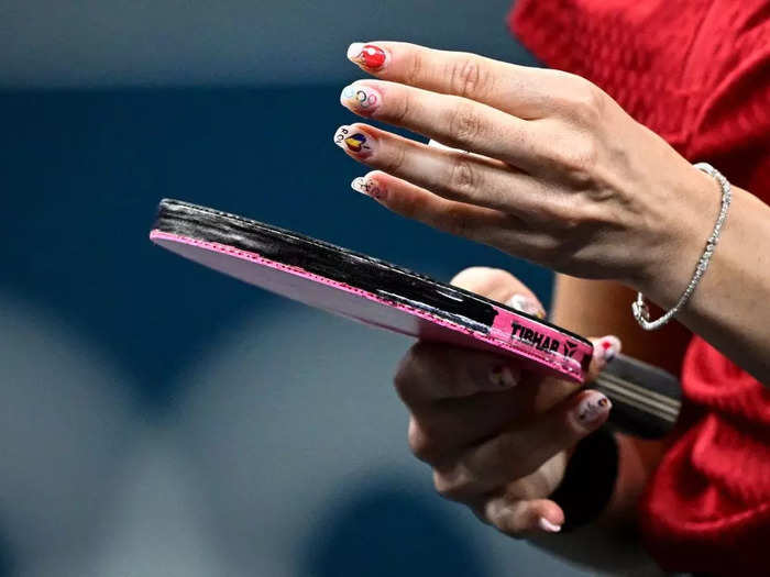 Romanian table tennis player Bernadette Szocs painted a miniature table tennis racket on her pointer finger.