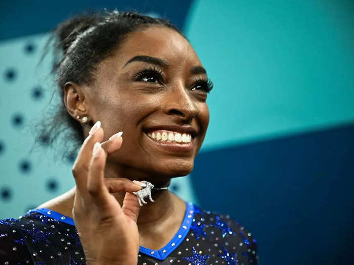 Biles celebrated her all-around gold medal with a diamond goat necklace, symbolizing her status as the GOAT or greatest of all time.