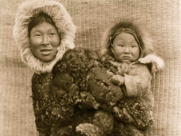 1929: A mother carries her child on Nunivak Island. Today, the entire island only has one town, Mekoryuk.