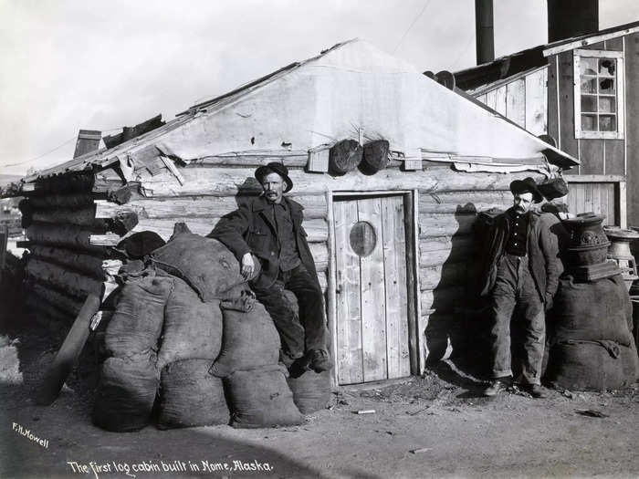 1900: According to the handwritten note on this photo, this was the first log cabin built in Nome, Alaska, amid the gold rush.