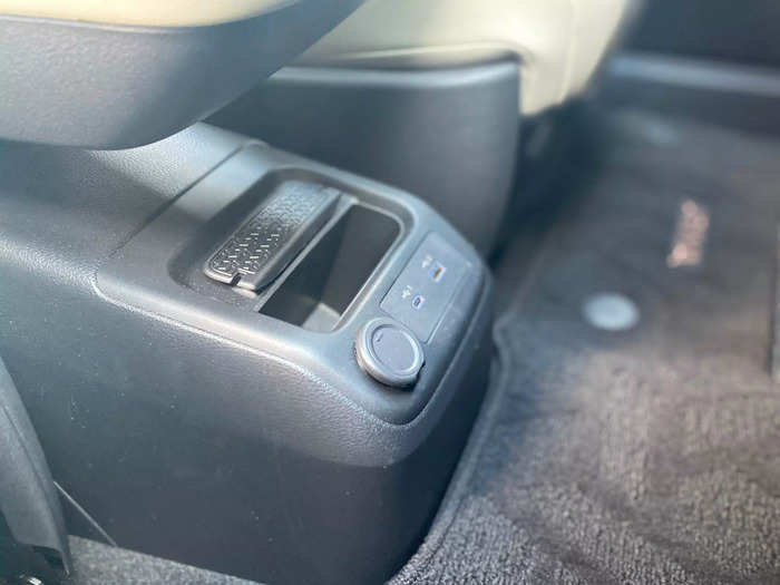 At the bottom of the center console, there are a pair of USB plugs and a slot for your mobile device. 