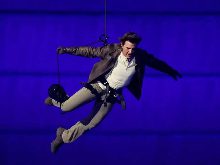 Tom Cruise jumped from the top of the stadium to retrieve the Olympic flag.