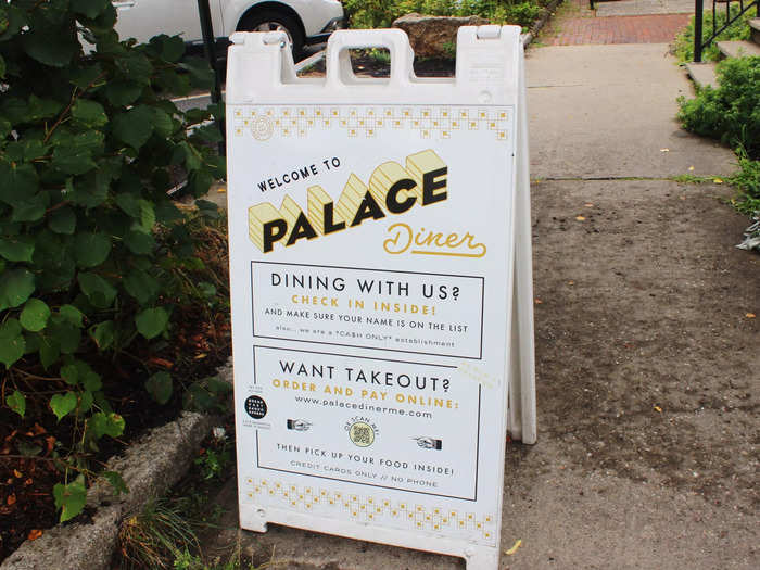 A sign outside the restaurant explained that you could check in with the host inside to be put on the list, or order takeout.