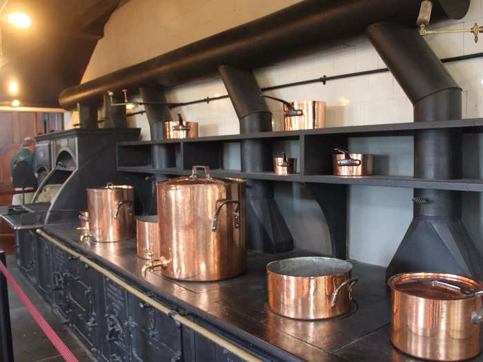 In the kitchen, an enormous cast-iron stove was powered by coal and wood as a team of cooks prepared French cuisine for the Vanderbilts.